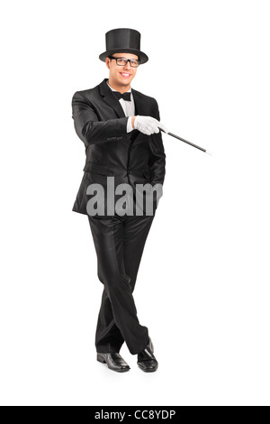 Full length portrait of a magician holding a magic wand posing Stock Photo