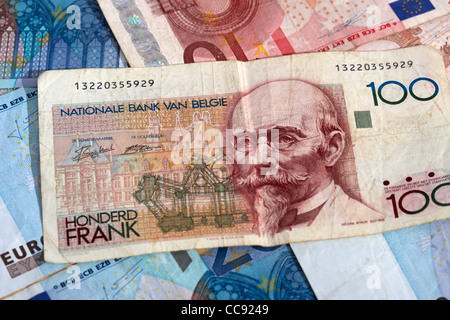 100 belgian francs pre euro national currency on pile of euros Stock Photo