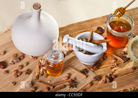 Honey and all sorts of nuts on wooden shelf Stock Photo