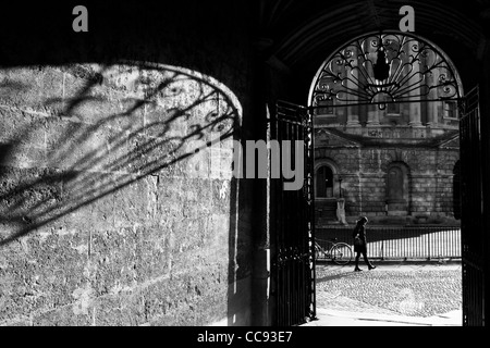 View of the Radcliffe Camera from the Brasenose College. Oxford, England. Girl walking, head bowed. Stock Photo