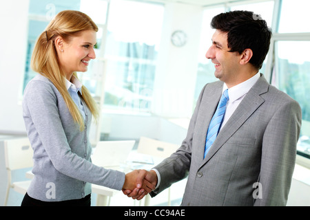 Portrait of happy business partners shaking hands at meeting Stock Photo