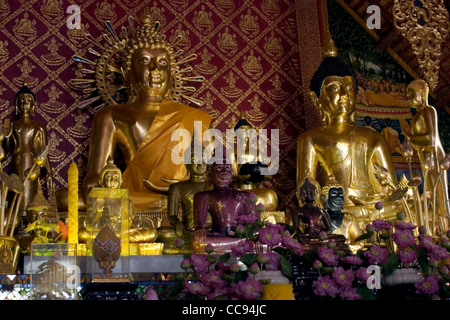 Many gold Buddhist statues are on display inside a beautiful pagoda in Chiang Rai, Thailand. Stock Photo