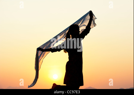 Indian girl with veil in the wind silhouette Stock Photo