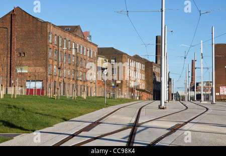 New Metrolink East Manchester Line line to Ashton passes old cotton mills (Chapeltown St ), Ancoats area , Manchester,UK Stock Photo