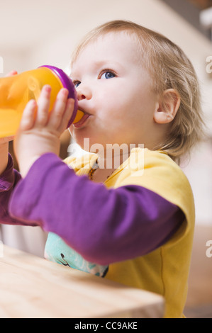 Baby Girl Drinking from Spill Proof Cup Stock Photo