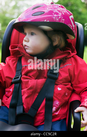 Baby Girl in Baby Bicycle Seat, Sweden Stock Photo