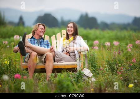 Couple on Bench in Field, Portland, Oregon, USA Stock Photo