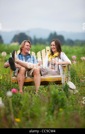 Couple on Bench in Field, Portland, Oregon, USA Stock Photo