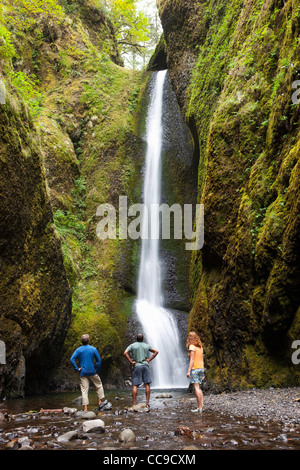 People Hiking and Looking at Waterfall, Oneonta Gorge, Oregon, USA Stock Photo