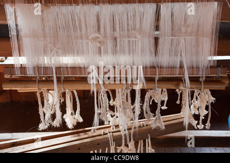 Close up of staple on loom in weaving workshop in Burma. Stock Photo