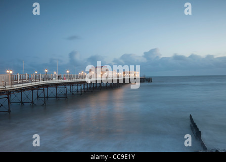 Evening view of Worthing pier, Sussex, illuminated at sunset. Stock Photo