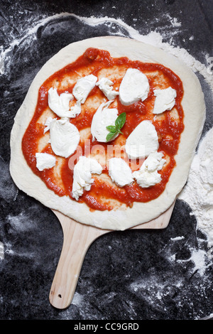 Raw pizza in the making Stock Photo