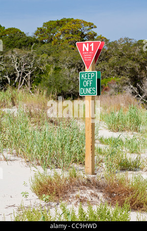 Signs attempt to keep visitors off sand dunes at Driftwood Beach on Jekyll Island, Georgia Stock Photo