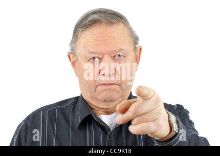 Portrait of old senior man pointing at camera looking angry. Stock Photo