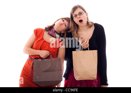 Two young women tired of shopping, isolated on white background. Stock Photo