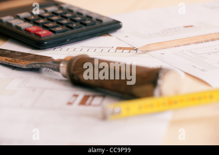 Carpenter planning his work - still life of tools, pencil, calculator and blueprint Stock Photo