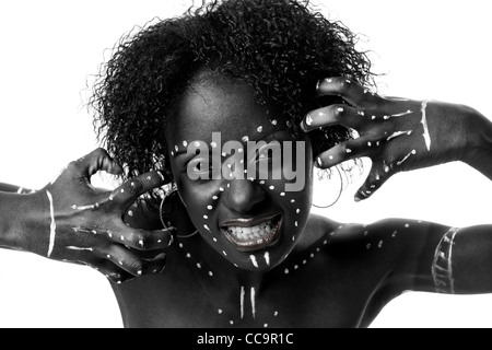 Beautiful African indigenous tribal fashion female face with white dots and stripes and aggressive expression, isolated. Stock Photo