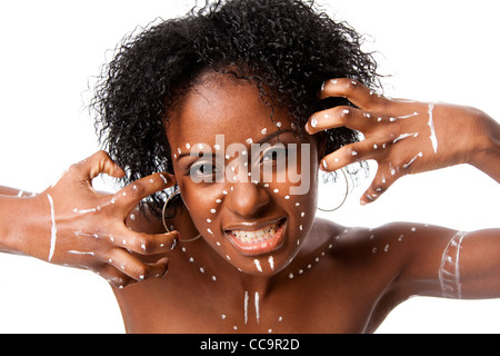 Beautiful African indigenous tribal fashion female face with white dots and stripes and aggressive expression, isolated. Stock Photo