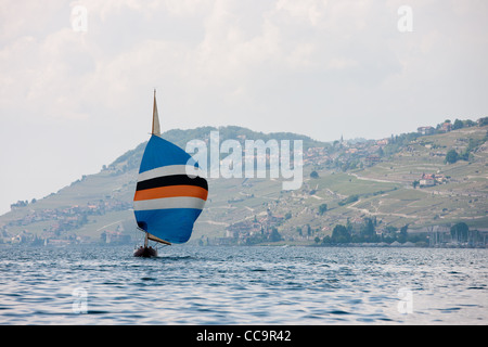 Sailboat on Lake of Geneva (Lac Léman) near Montreux city. In the distance, hills and vineyards. Switzerland Stock Photo