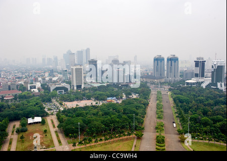 Hazy view over the Indonesian capital Jakarta from the National Monument (Monas) in Merdeka Square built by President Sukarno. Stock Photo