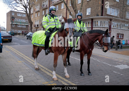 Two mounted Metropolitan Police Officers on patrol outside WHite Hart Land football Stadium in North London, UK. Stock Photo