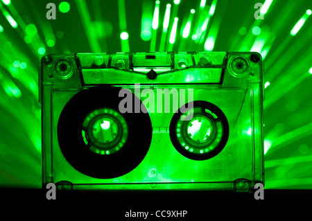 Transparent Cassette tape and green color disco lights background Stock Photo