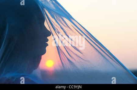 Indian girl and veil at sunset. Silhouette. Andhra Pradesh, India Stock Photo