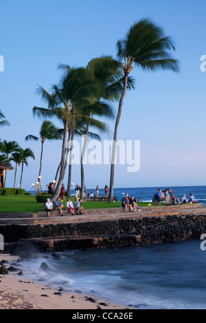 Visitors enjoying sunset at Lawai Beach, Po'ipu, Kauai, Hawaii. Stock Photo