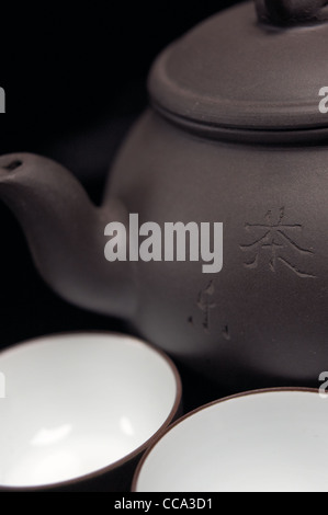 chinese jasmine tea pot and cups over black Stock Photo
