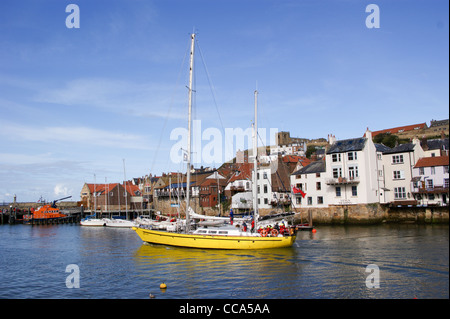 Sailing yacht 'James Cook' leaving Whitby Harbour, North Yorkshire, England Stock Photo