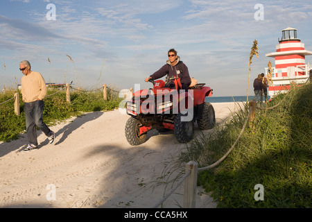 A life guard on South Beach Miami taking his dune buggy back to its garage after work Stock Photo