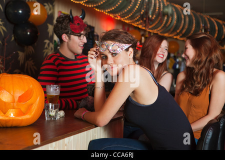Young friends sitting in bar Stock Photo
