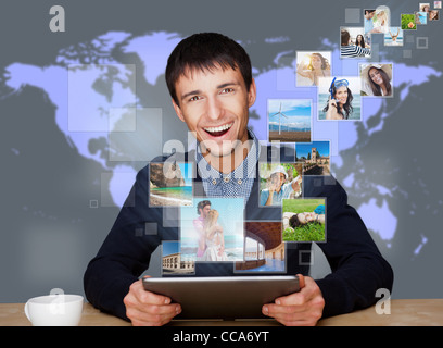 A technology man has images flying away from his modern tablet computer. Designed poster for a communication, social media Stock Photo