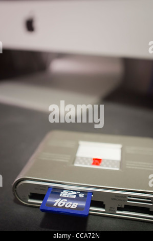 Multi memory card reader on computer desk Stock Photo