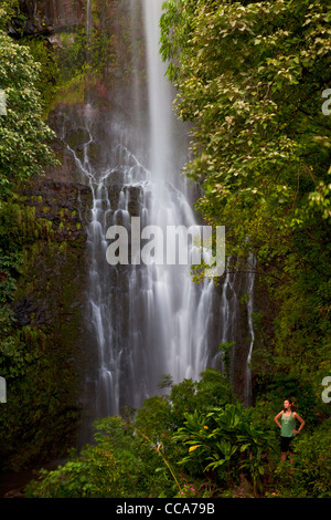 A visitor at Wailua Falls, near Hana, Maui, Hawaii. Stock Photo