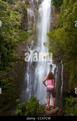 A visitor at Wailua Falls, near Hana, Maui, Hawaii. (model released) Stock Photo