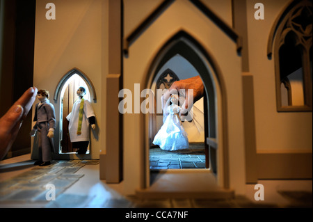 A vicar by Woodside Dolls with the groom before a wedding scene inside 'All Saints Church' by Barbara's Mouldings at 'Miniatura' Stock Photo