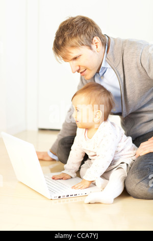 Father and Baby Girl Using Laptop Stock Photo