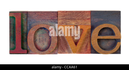 the word love in vintage wooden letterpress type blocks, stained by color ink, isolated on white Stock Photo