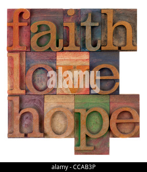 biblical, spiritual or metaphysical reminder - faith, hope and love in old wooden letterpress type blocks Stock Photo