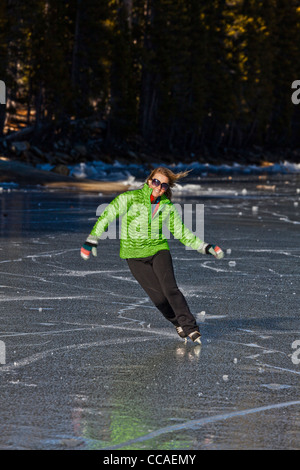 Ice skating on frozen Tenaya Lake in Yosemite National Park. Stock Photo