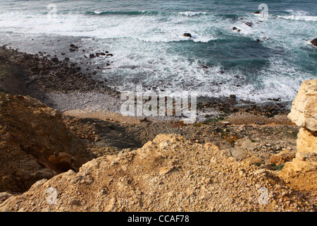 Looking over the cliffs onto the deserted beach at Praia das Bicas, Aldeia do Meco, close to Sesimbra in Portugal. Stock Photo