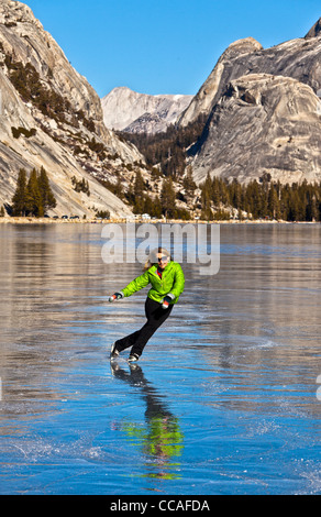 Ice skating on frozen Tenaya Lake in Yosemite National Park. Stock Photo