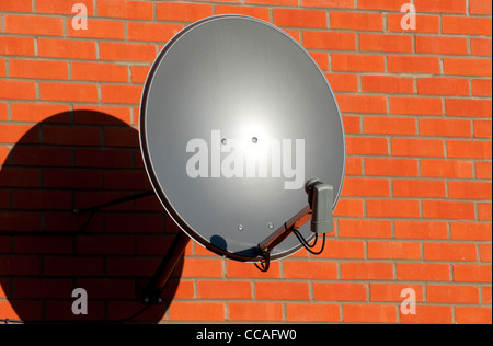 satellite dish on brick wall