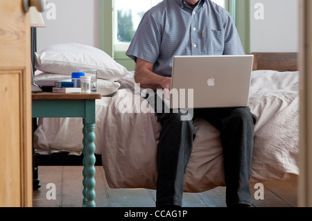 senior male using laptop computer Stock Photo