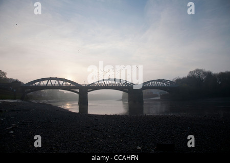 Barnes Bridge in fog at sunset, London Stock Photo