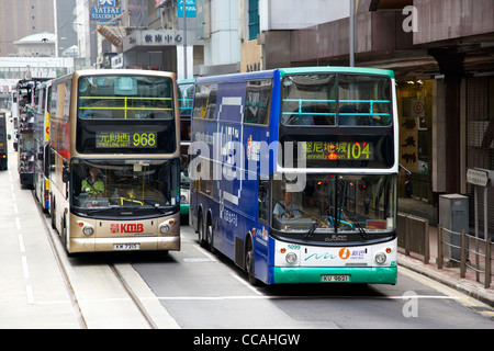 two modern double deck hong kong busses from different companies hksar china asia Stock Photo