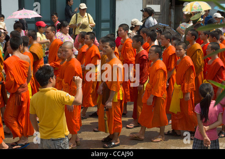 Buddhist monks in procession on Mue Nau, the middle day of Lao New Year (Pi Mai Lao), Luang Prabang, Laos Stock Photo