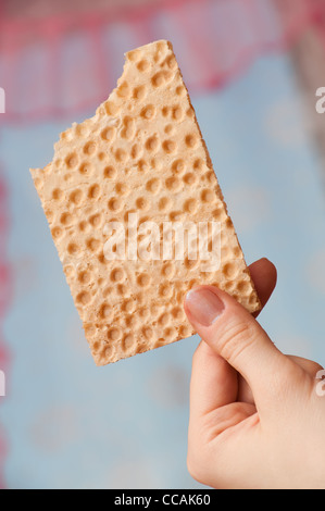 bitten bread crisps in a hand Stock Photo