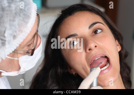 patient’s open mouth during oral checkup with mirror near by Stock Photo